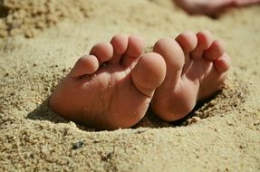 barefoot in beach sand close-up