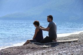 woman is doing massage on the beach