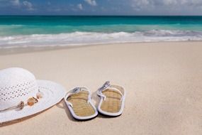 beach hat and flip-flops on the beach