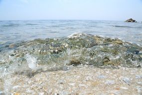 stones and sand in the waves of the ocean