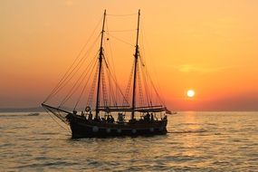 sailing boat with rigging at sunset