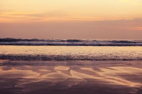 sand near the surf at sunset