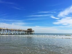 long pier on beach at ocean, usa, florida