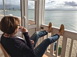 holiday relaxed woman sitting near north sea beach