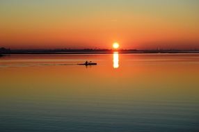 Orange sunset canoe sea view