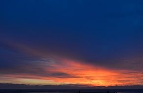 dark clouds with orange light at sunset