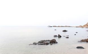 stones in the water on the coast