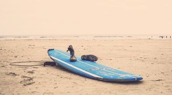 surfboard on a sand beach