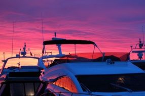 boats on a background of pink sunset in Norway