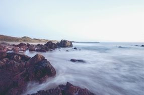 fog over the rocky ocean coast