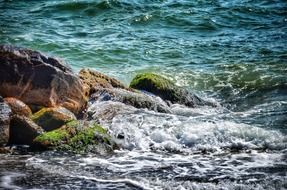 Beautiful and colorful waves about coastal stones