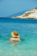 girl swims in hat