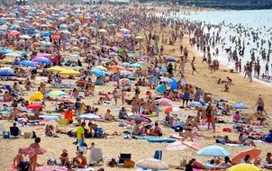 a crowd of people on the sandy beach