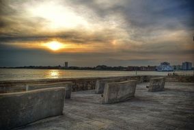 stone benches in front of sea at sunset, england, hampshire, portsmouth