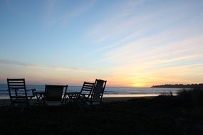Chairs on the beach under the sunset