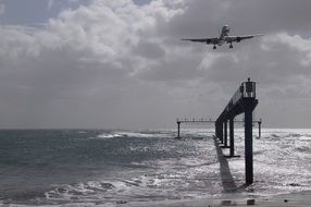 aircraft in flight over the pier