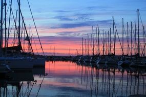 red sunset with sailing boats scenery