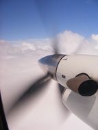 airplane propeller in white clouds