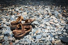 old sandals is lying on stones