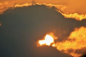 fiery sun in dark clouds