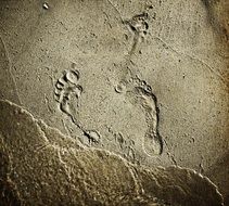 footprints on wet sand beach