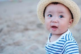 happy child with hat on the beach
