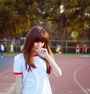 Pensive girl at the stadium