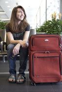 woman with a red suitcase