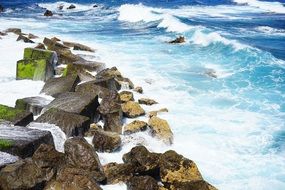 stones in white sea foam waves