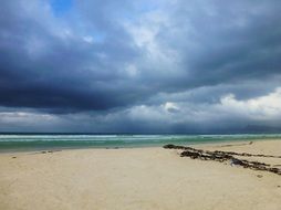 gloomy clouds on the beach by the sea