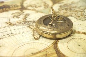 antique compass on world map