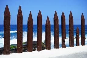 wooden fence along the seashore