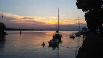 boats near the shore of Lake Garda at sunset