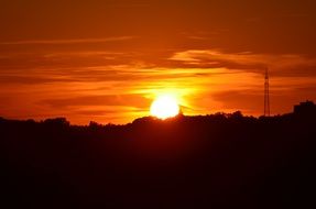 golden sunset glow with power line silhouette