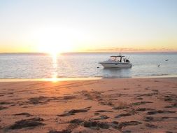 boats on the water at bright sunset