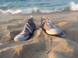 sneakers with laces in the sand