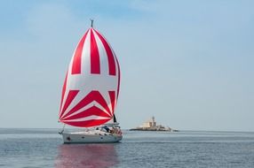boat with a bright sail on the Mediterranean
