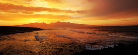 orange sunset over the seashore in hawaii