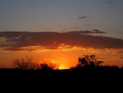 bright orange sunset glow beneath clouds