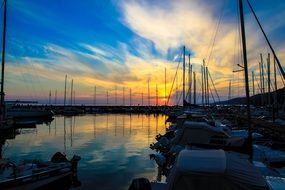 sailing boats in harbor at great sunset