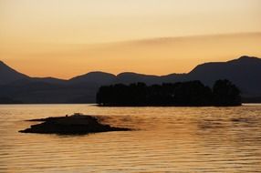 sunset over the hills by the lake