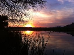 sunset over the silhouettes of beautiful nature