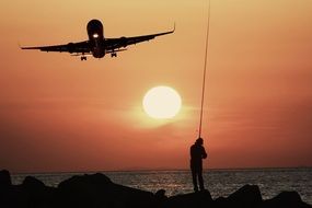 aircraft over the coastline at sunset