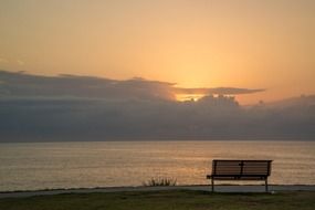 bench by the sea during sunrise