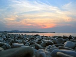 pink sunlight sky with sea stones landscape