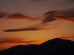 dark orange sunset over the hills