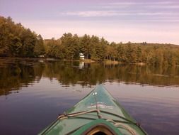 green boat in a quiet lake