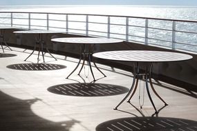 dining tables on the open deck of the ship