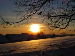 golden sunset over snowy fields