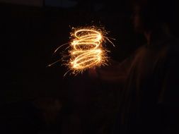 sparkler in man’s hand at night